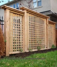 a wooden fence in front of a house