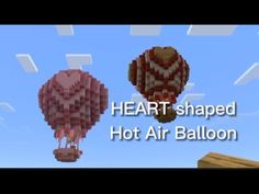 two hot air balloons floating in the sky with text that reads heart shaped hot air balloon