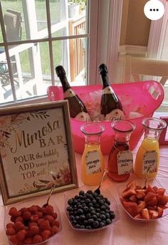 a table topped with fruit and drinks next to a framed sign that says minnesota bar