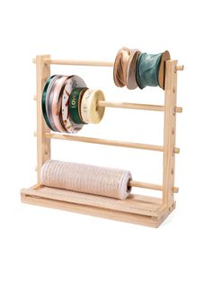 a wooden rack with spools of thread on it