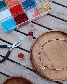 beads, scissors and other crafting supplies on a wooden table