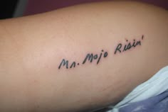 a woman with a tattoo on her arm that reads, m m mip rin