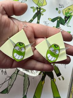 "CRYSTAL CLODS"  Peridot is 2 inches long and hang on regular earring hooks, she also has the COOLEST iridescent acrylic glasses. If you need different earring hooks, please let me know :) WILL RESTOCK AS NEEDED! Steven Universe Earrings, Green Plastic Earrings For Gifts, Handmade Clear Plastic Earrings, Fun Green Plastic Jewelry, Green Fun Plastic Jewelry, Green Plastic Jewelry For Gifts, Green Resin Fun Earrings, Nerd Jewelry, Peridot Steven Universe