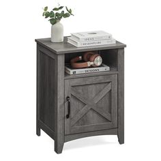 a small wooden cabinet with books and a potted plant on it's side