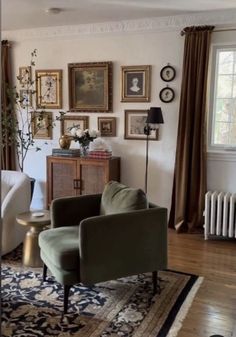 a living room filled with furniture and pictures on the wall next to a radiator