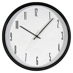 a black and white clock with numbers on the face is seen against a white background