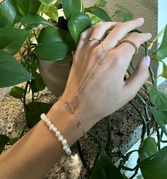 Hand chain Hand Chain is handcrafted in 14K gold-filled and embellished with dangling bezeled white CZ gemstones. L E T S . T A L K . H A N D . C H A I N ✤ Available in 14k Gold Filled or Sterling Silver ✤ Bezel CZ setting stone ✤ Bracelet Length (wrist): 6" with 1" extension at clasp to adjust size ✤ Ring size is crafted for one size fits all. ✤ Extremely delicate but very durable and comfortable. ✤ Tarnish resistant ✤ Safe for sensitive skin All purchased items will arrive in a Tommassini Jewelry box, If you purchase more than one item, I will place it all into one box, unless requested otherwise in a note. All Tommassini pieces are handmade by me, with love, in my Los Angeles based studio. All my designs are original and sometimes even a one of a kind if stated. After an order has been Gold Plated Dangle Chain Bracelet With Adjustable Chain, Adjustable Gold Plated Chain Bracelet, Finger Bracelets, Hand Chain Bracelet, Ring Bracelet Chain, Jewelry Chain, Hand Bracelet, Jewelry Lookbook, Hand Chain