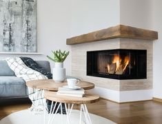 a living room with a couch, coffee table and fire place in the fireplace area