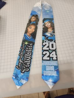 two blue and white neck ties with images of women on them, one for the 2012 johnson high school football team