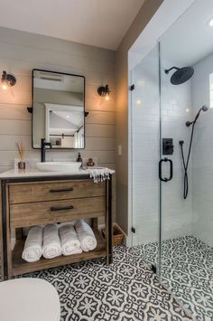 a bathroom with a sink, toilet and shower