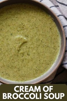 a bowl filled with broccoli soup on top of a towel