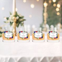 four jars filled with food sitting on top of a table