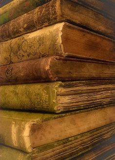 a stack of old books sitting next to each other