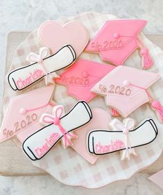 decorated cookies with graduation caps and tassels on a tray for someone to decorate