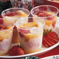 four glasses filled with fruit on top of a white plate