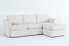 a white couch with a footstool sitting next to it on a white background