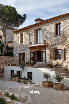 an image of a house that looks like it is built in stone and has many windows