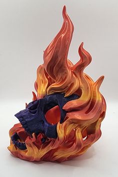 a colorful fire skull sculpture sitting on top of a white table