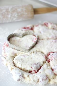 heart shaped cookies sitting on top of a white counter