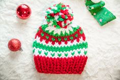 Perfect for baby's first Christmas!  Add some festive flair to your little one's holiday ensemble with an adorable fair isle or red and white striped Christmas Hat! Hand-knitted with love, these cozy holiday hats feature classic red, green, and white patterns that instantly bring joy and cheer.  Crafted with care, these kid's knit holiday hats are not only adorable but also keep your child warm and stylish during the winter festivities. This hat is a must-have for any little elf this season, per Christmas Crochet Hats, Fair Isle Christmas, Crochet Christmas Hats, Christmas Card Pictures, Holiday Hats, Yarn Pom Pom, Cozy Holiday, Gifts For New Parents, Knitting For Kids