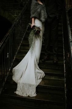 the bride and groom are walking down the stairs