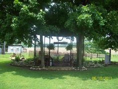 a fenced in area with trees and plants