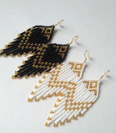 the beaded earrings are black, white and gold