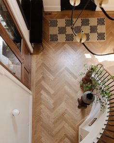 an overhead view of a spiral staircase with potted plants