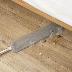 a knife that is laying on the floor next to some wood chips and something else