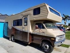 an rv parked in front of a garage