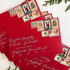 four red envelopes with christmas stamps on them