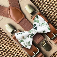 "This sage floral bow tie & brown vegan leather suspender set is a great choice for family photos, groomsmen gift, weddings, ring bearer outfit, gift, birthday celebration or any other special occasion. ❤ **Please Specify**  Bow Tie Only (w/ Clip or Neck Strap), Suspenders Only, or Bow Tie Only & Susp (Bow Tie and Suspenders) SUSPENDERS- One Pair of our Quality Suspenders BOW TIE - One Bow Tie on White Adjustable STRAP or Alligator CLIP PET BOWTIE w/ Elastic Loops- Slips on a Dog/Cat/Pet Collar **CLIP ON Bow Ties are Recommended/Suitable for Children Only X-Small: 6 months- 2 years Small: 3 years- 5 years Medium: 6 years- 10 years Large: 10 years- Up To 6ft tall Adult: Adults Over 6ft Tall RUSH MY ORDER- Need you order ASAP? Simply add this to your cart before checkout: https://www.etsy.co Green Wedding Ring Bearer, Sage Green Ring Bearer Outfit, Country Ring Bearer Outfit, Sage Ring Bearer, Sage Green Accessories, Wedding Ring Bearer Outfit, Weddings Ring, Ring Bearer Gift, Wedding Ring Bearer