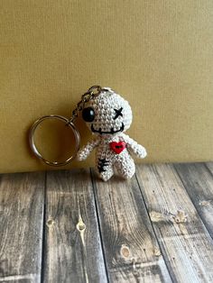 a crocheted keychain with a stuffed animal hanging from it's side