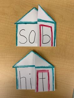 two paper houses with the words sold and hit written on them