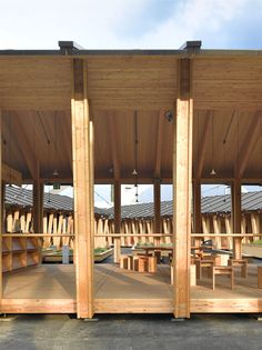 a wooden structure with benches and tables in it