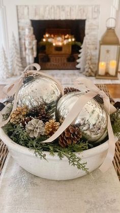 a bowl filled with ornaments on top of a table next to a fireplace in a living room