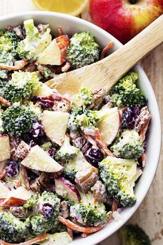 broccoli, potatoes and cranberries are mixed together in a large bowl