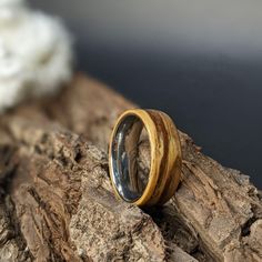 a wooden ring sitting on top of a rock