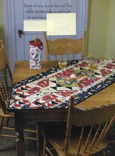 a quilted table runner sitting on top of a wooden table next to two chairs