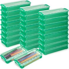 green plastic storage containers with pens and pencils in each container on the bottom one is filled with colored pencils