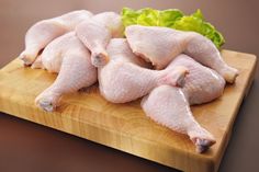 raw chicken legs on a cutting board with lettuce stock images and royalty photos