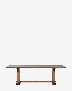 a wooden table sitting on top of a white wall