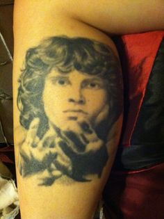 a woman's leg with a portrait tattoo on it, in the middle of her legs