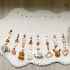 a collection of wooden beads and toys on a white rug next to a wood wall