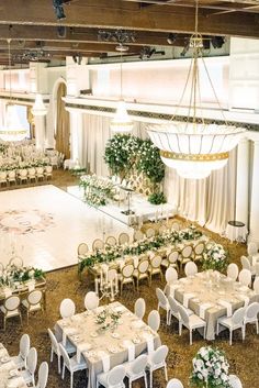 a banquet hall with tables and chairs set up for an event