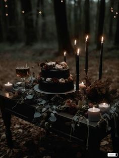 a table topped with a cake covered in candles