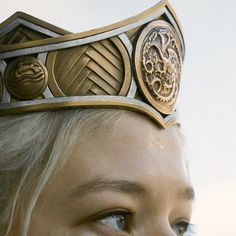 a close up of a person wearing a crown