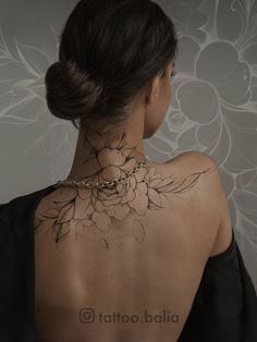 a woman with a flower tattoo on her back