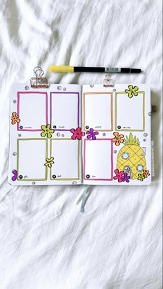 an open planner with pineapples and flowers on it, next to a pencil