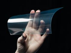 a person holding up a piece of clear plastic